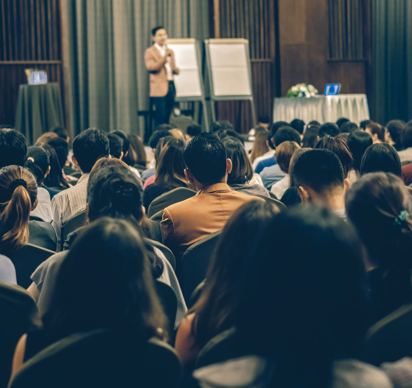 Abstract blurred photo of conference hall or seminar room with attendee background