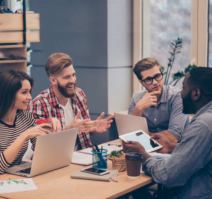 Portrait of happy creative team talking in office on meeting.